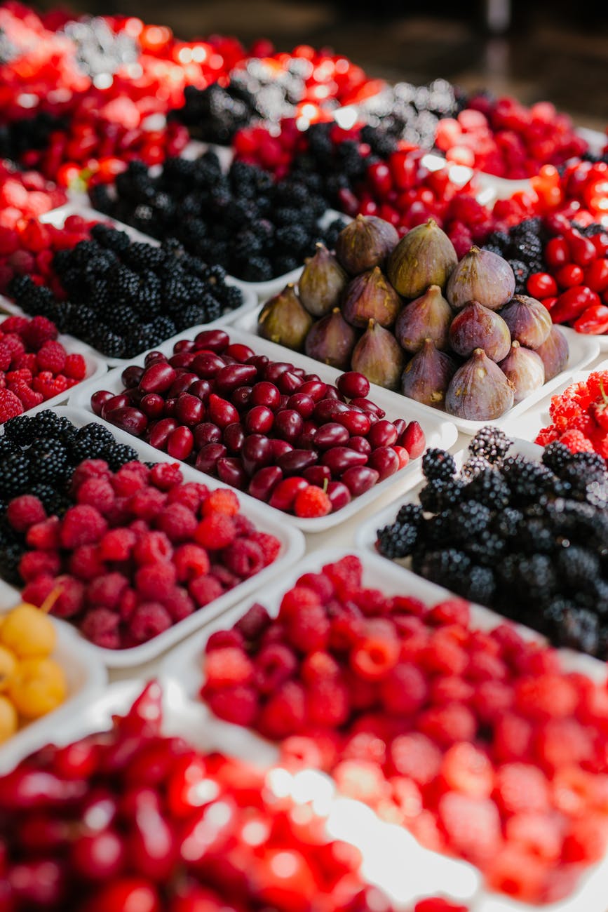 fresh berries on trays in market